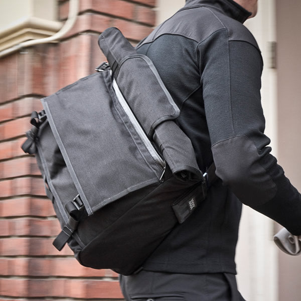The Rummy messenger bag showing roll top compartment